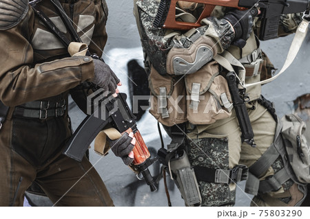 The military with machine guns perform the task in the winter. 75803290