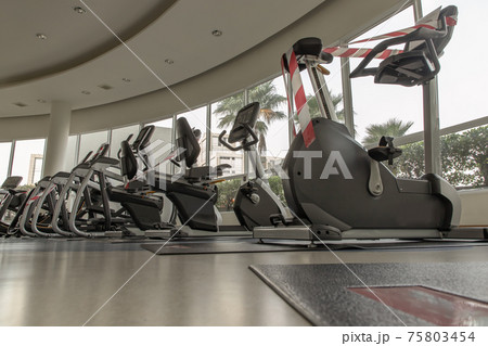 New normal concept and physical distancing people exercise on Training exercise bikes in fitness. 75803454