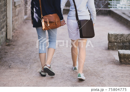 LGBT Two lesbian girls walk around the city and hold hands 75804775