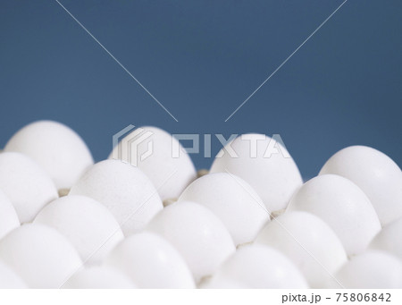 Chicken eggs in a cardboard boxon a light blue background, Raw Fresh Chicken Eggs in a paper container, Natural Eko Product, Copyspace 75806842