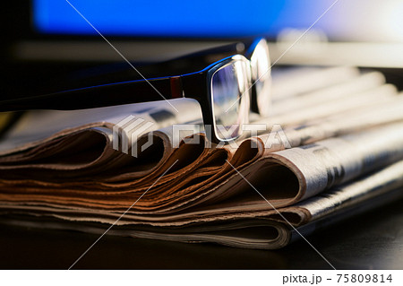 Glasses and newspapers journalism concept Glasses and newspapers journalism concept 75809814