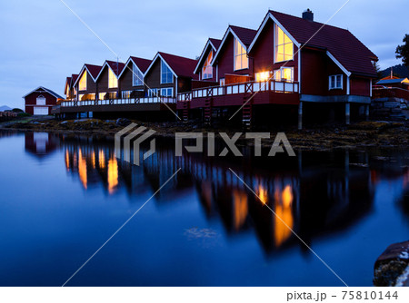 Camping cabins on a fjord at night 75810144
