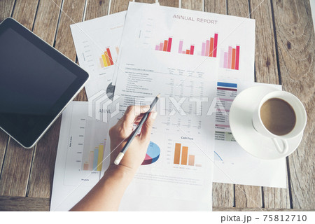 Office laptop business financial document chart and graph on wooden table with coffee cup. Flat lay notebook computer laptop on office desk. No people business graph chart mockup on business workspace Office laptop business financial document chart and graph on wooden table with coffee cup. Flat lay notebook computer laptop on office desk. No people business graph chart mockup on business workspace 75812710
