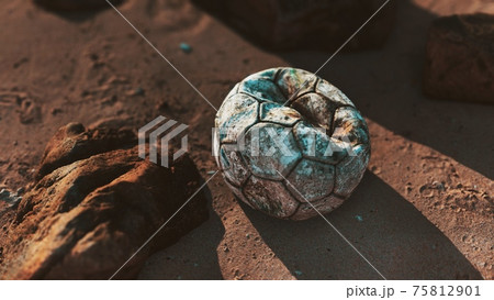 Old leather soccer ball abandoned on sand Old leather soccer ball abandoned on sand 75812901