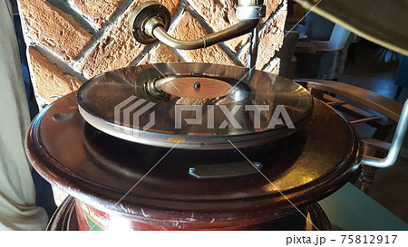 Gramophone with plate or vinyl disk. Antique brass record player. Gramophone with horn speaker. Gramophone with plate or vinyl disk. Antique brass record player. Gramophone with horn speaker. 75812917
