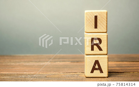 Wooden blocks with the word IRA - individual retirement account. Tax-advantaged account that individuals use to save and invest for retirement. Business and finance concept Wooden blocks with the word IRA - individual retirement account. Tax-advantaged account that individuals use to save and invest for retirement. Business and finance concept 75814314