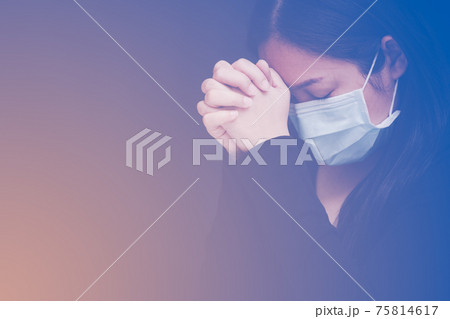 woman praying and worship to GOD Using hands to pray in religious beliefs and worship christian in the church or in general locations in vintage color tone or copy space. 75814617