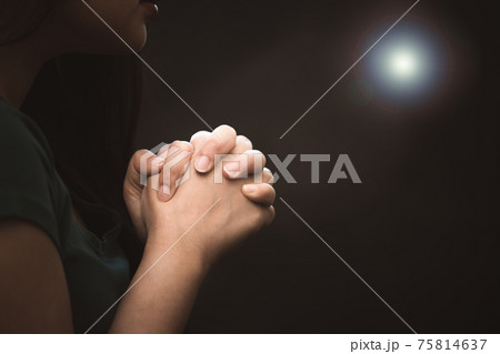 woman praying and worship to GOD Using hands to pray in religious beliefs and worship christian in the church or in general locations in vintage color tone or copy space. 75814637