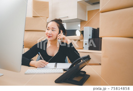 Asian beautiful woman Receiving order by phone and notebooks in selling products online, Working at home the technology to buy and sell of online, preparing products for delivery to customers 75814858