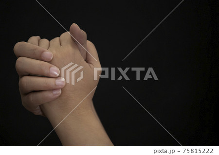Woman's hand praying and worship to GOD Using hands to pray in religious beliefs and worship christian in the church or in general locations in black background or copy space. Woman's hand praying and worship to GOD Using hands to pray in religious beliefs and worship christian in the church or in general locations in black background or copy space. 75815222