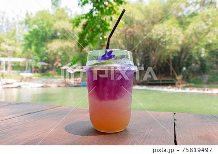 glass of cold italian soda on wooden bar by lake glass of cold italian soda on wooden bar by lake 75819497