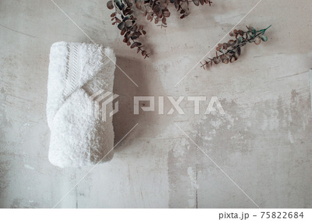 Boutique spa towel product shot with a eucalyptus plant. 75822684