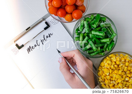 Meal plan. Three Bowls of frozen vegetables food of yellow corn, green beans, red tomatoes. Colors of traffic light. Harvest Food preservation for winter. 75826670
