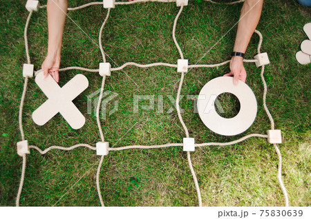 Tic tac toe game on the green grass. Tic tac toe game on the green grass. 75830639