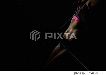 Close up of young slim female stomach near the pole. 75830932