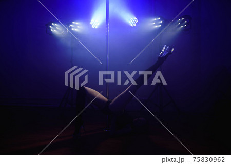 An attractive sexy woman pole dancer performing 75830962