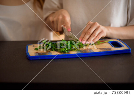 Young sisters making vegetable salad at home. Young sisters making vegetable salad at home. 75830992