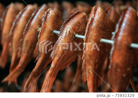 Smoking sea bass fish in smokehouse box 75831320