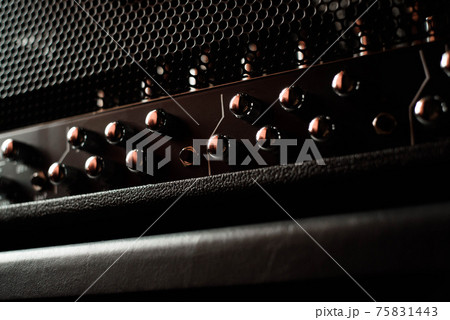 A guitar combo amplifier or speaker closeup on black background A guitar combo amplifier or speaker closeup on black background 75831443