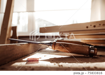 Carpenter's chisel, woodwork tool on the desktop in the workshop 75833816