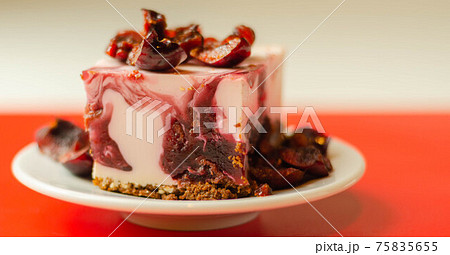 Japanese cheesecake with cherry sauce and fresh cherries on the ceramic plate and red background Japanese cheesecake with cherry sauce and fresh cherries on the ceramic plate and red background 75835655