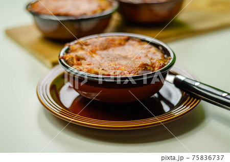 Traditional french onion gratin soup served in a ceramic bowl Traditional french onion gratin soup served in a ceramic bowl 75836737