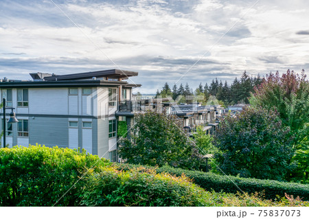 Top of residential building on cloudy sky background Top of residential building on cloudy sky background 75837073
