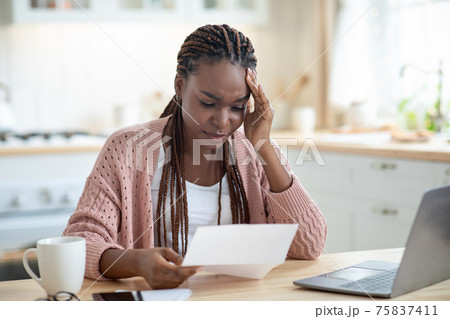 African American Female Freelancer Having Stress While Working With Papers At Home African American Female Freelancer Having Stress While Working With Papers At Home 75837411