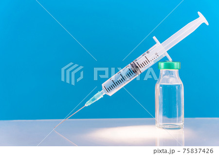 Potential trials stage concept on blue background. Close up Vials with sterile needle syringe. Research and Development, Vaccination. Potential trials stage concept on blue background. Close up Vials with sterile needle syringe. Research and Development, Vaccination. 75837426