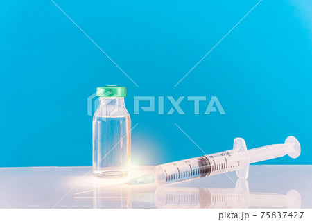 Potential trials stage concept on blue background. Close up Vials with sterile needle syringe. Research and Development, Vaccination. Potential trials stage concept on blue background. Close up Vials with sterile needle syringe. Research and Development, Vaccination. 75837427