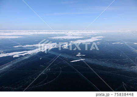Frozen Baikal Lake in February day 75838448