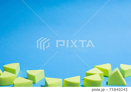 Make-up yellow sponges on a blue background Make-up yellow sponges on a blue background 75840245
