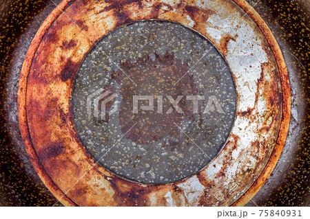 frying pan bottom view of the burnt greasy surface of the coating of utensils for cooking on a fire close-up. 75840931