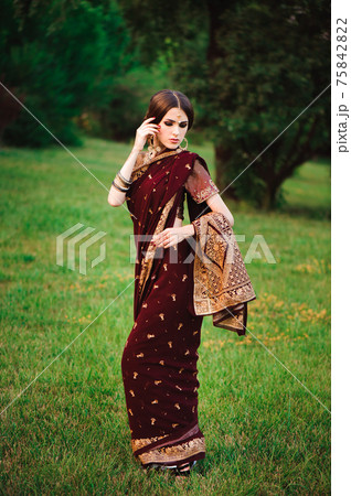 Beautiful Arabian woman portrait. Young Hindu woman with mehndi tattoos from black henna on her 75842822