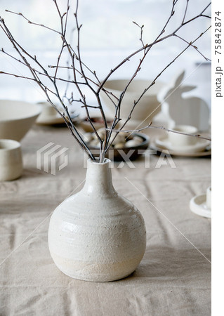 Spring birch branches in white ceramic vase 75842874