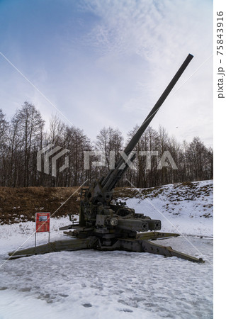 Russia. March 14, 2021. The KC-130 130-mm anti-aircraft gun of the 1952 model is displayed in the open air as a museum exhibit in the Patriot Park of the city of Kronstadt. Russia. March 14, 2021. The KC-130 130-mm anti-aircraft gun of the 1952 model is displayed in the open air as a museum exhibit in the Patriot Park of the city of Kronstadt. 75843916