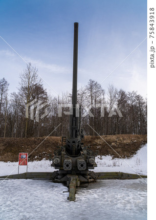 Russia. March 14, 2021. The KC-130 130-mm anti-aircraft gun of the 1952 model is displayed in the open air as a museum exhibit in the Patriot Park of the city of Kronstadt. Russia. March 14, 2021. The KC-130 130-mm anti-aircraft gun of the 1952 model is displayed in the open air as a museum exhibit in the Patriot Park of the city of Kronstadt. 75843918