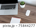Office at home. LaptOffice at home. Laptop. notebook. pen are on the table.op. notebook. pen are on the table. 75844277