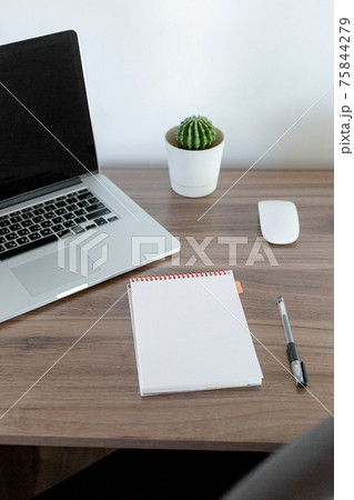 Office at home. LaptOffice at home. Laptop. notebook. pen are on the table.op. notebook. pen are on the table. 75844279