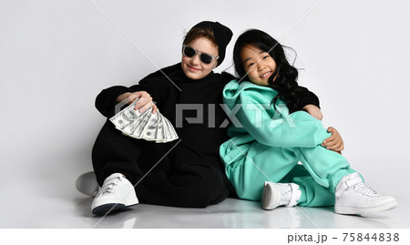 Trendy interracial sportive boy and girl sit on 75844838