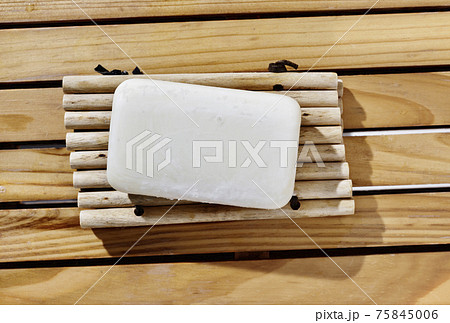 Bar of soap on wooden table 75845006