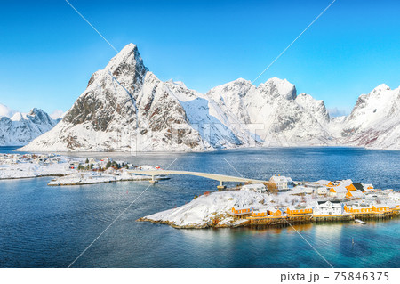 Aerial winter view on Sakrisoy village and snowy mountaines on background. 75846375