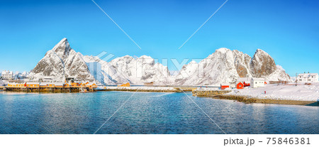 Breathtaking winter view of Sakrisoy village and snowy mountaines on background. 75846381