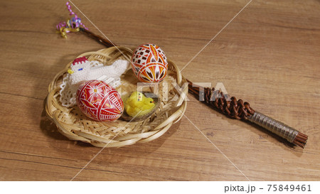 Czech rod with differently colored Easter eggs, wooden background 75849461