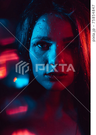 Sensual portrait of a beautiful attractive girl looking through the glass with raindrops Sensual portrait of a beautiful attractive girl looking through the glass with raindrops 75854847