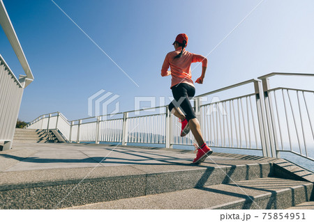 Healthy lifestyle fitness sports woman runner running on seaside trail Healthy lifestyle fitness sports woman runner running on seaside trail 75854951