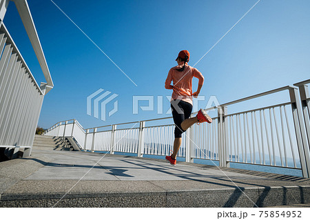 Healthy lifestyle fitness sports woman runner running on seaside trail Healthy lifestyle fitness sports woman runner running on seaside trail 75854952