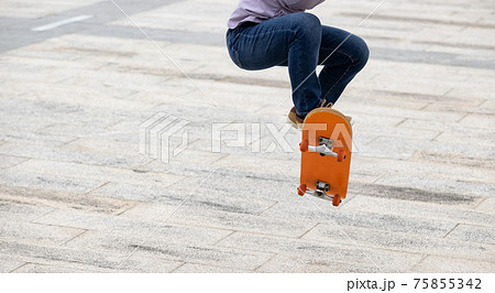 Asian woman skateboarder skateboarding in modern city Asian woman skateboarder skateboarding in modern city 75855342