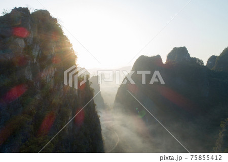 Aerial view of beatiful sunrise over karst mountain peak landscape 75855412