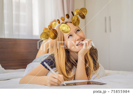 Obsessed with NFT. Young woman, a digital artist, creates digital art on a tablet at home and dreams of selling her NTF - non fungible token. Remote work, digital nomad, digital painting, animation 75855984